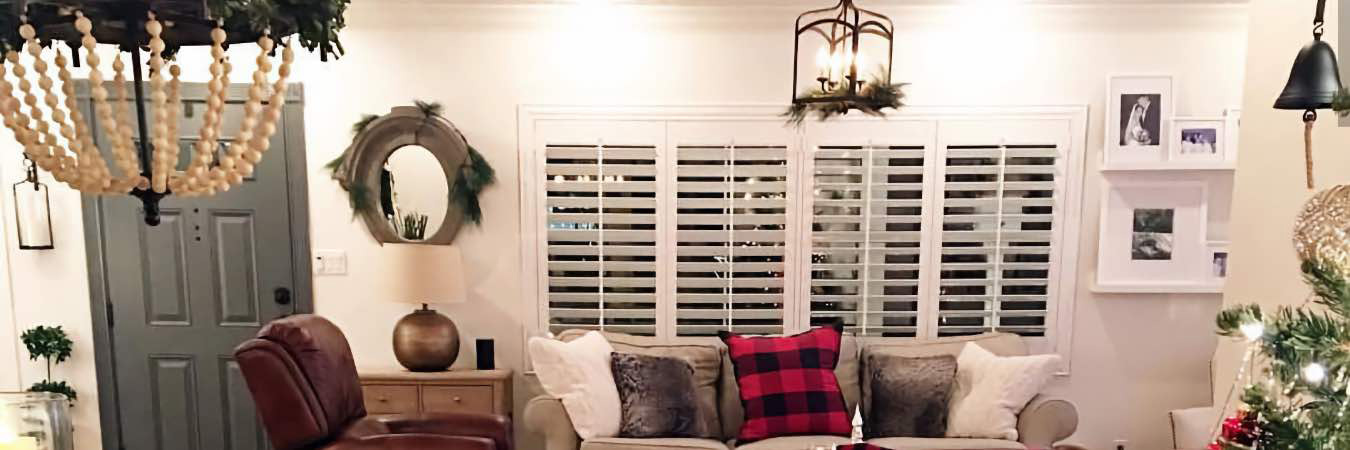 White Polywood Shutters in a large living room decorated for the holidays