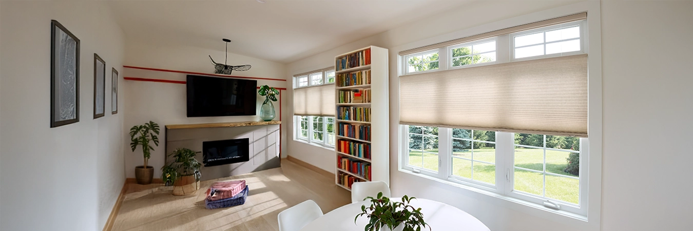 Beige top-down/bottom-up cellular shades on on a row of windows