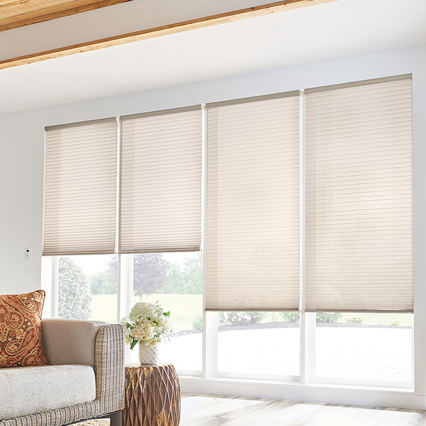 Beige cellular shades in a light and airy living room