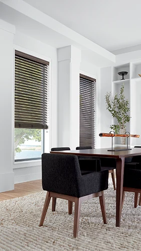 Dark wood faux blinds in a corner of a modern dining area