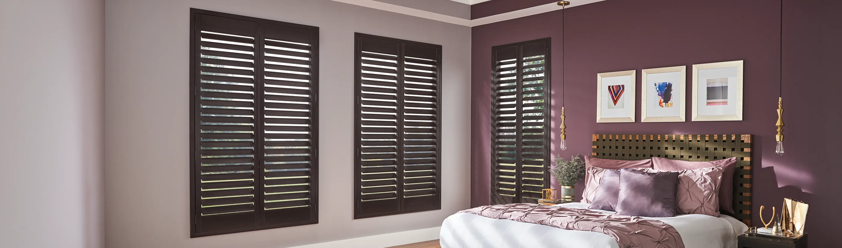 dark wood ovation shutters in a plum color bedroom on three windows
