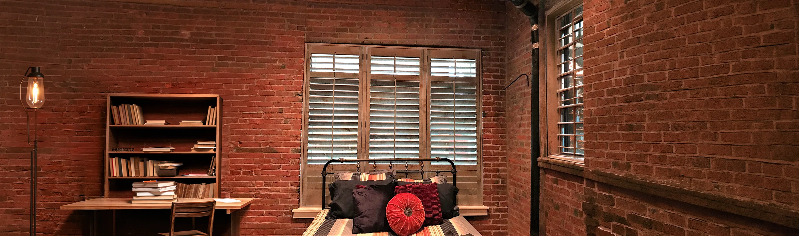 rustic wooden shutters above a couch in a beige living room