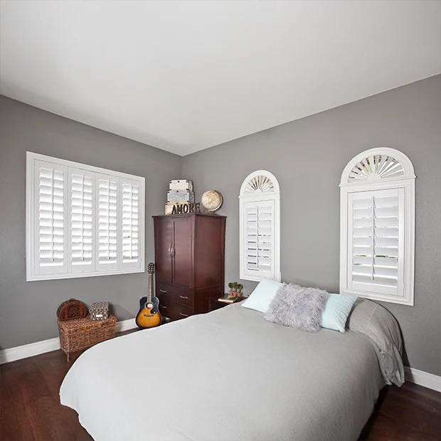 arched white shutters and white shutter windows in a young kid's bedroom