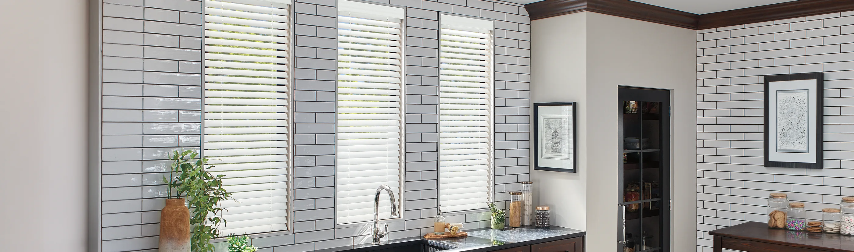 white blinds in three narrow windows above a kitchen sink