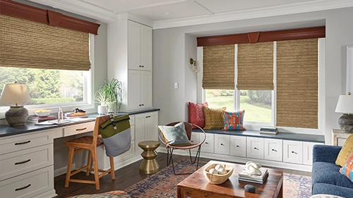 Light tan woven shades in two large window areas at a living room