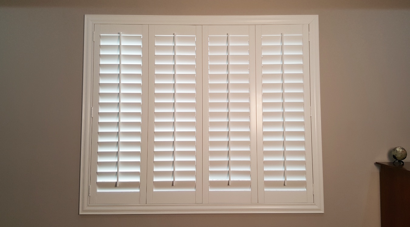 Interior custom shutters in a bedroom