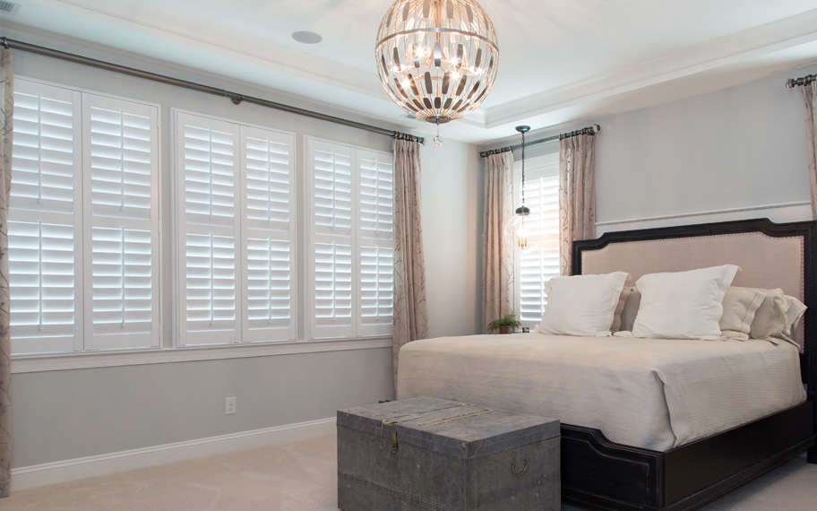 White polywood shutters in a bedroom