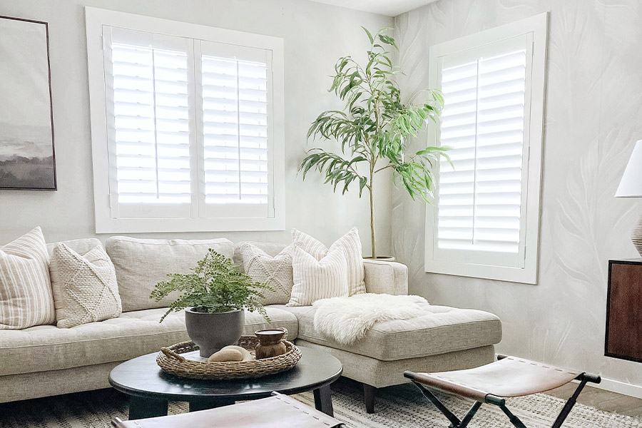 A modern farmhouse living space with white Polywood shutters.
