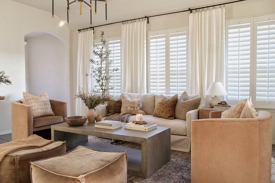 Polywood shutters dress up these living room windows and insulate them from drafts. Photo Credit: Brooke Morales Home A cozy living room with Polywood shutters.