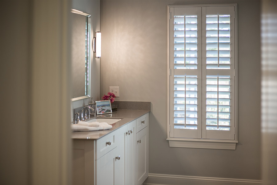 White Polywood shutter window inside a bathroom.