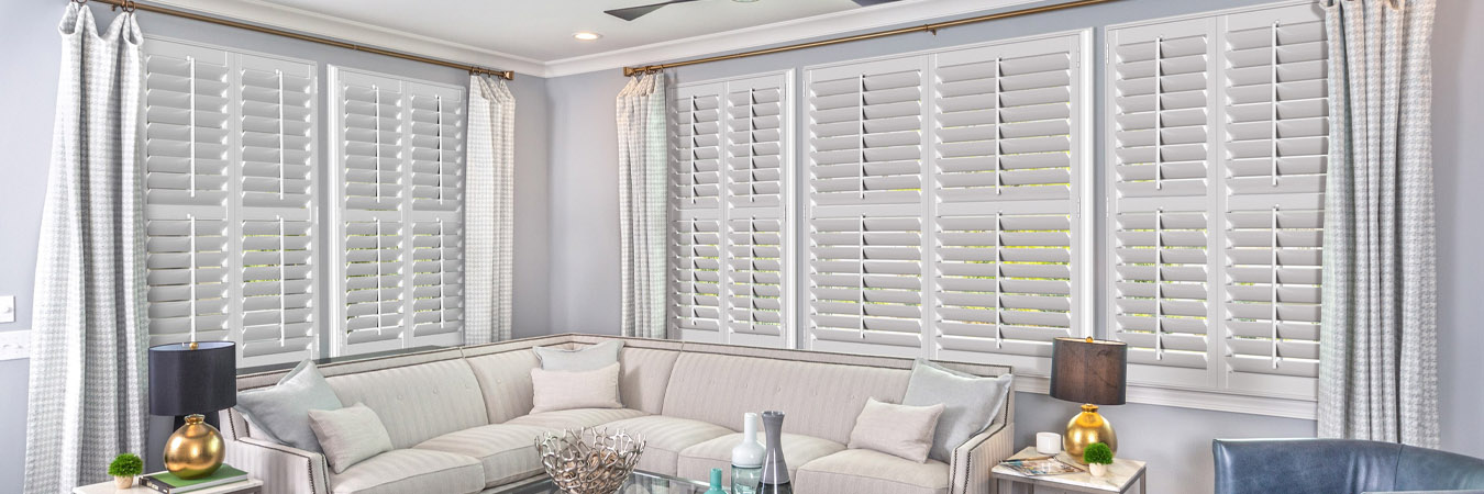 White split tilt shutters in a living room.