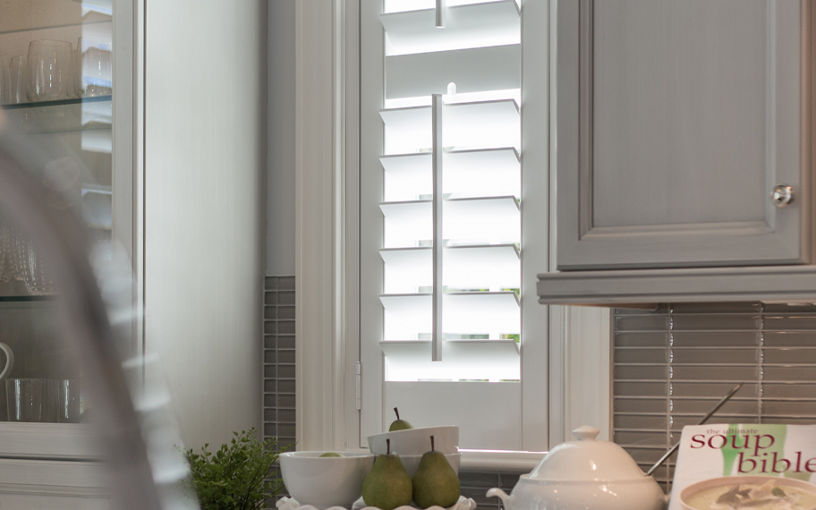 White split-tilt shutters in a kitchen.