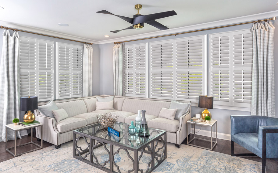Split tilt shutters work well in any room of the house. Split tilt shutters in a living room.