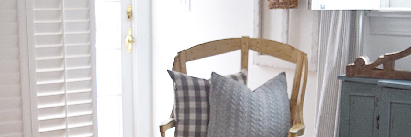 White polywood shutters in a corner of a living room