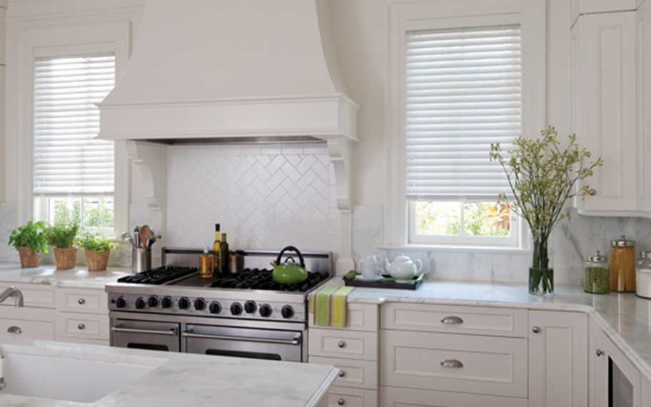 White faux-wood blinds in a kitchen.