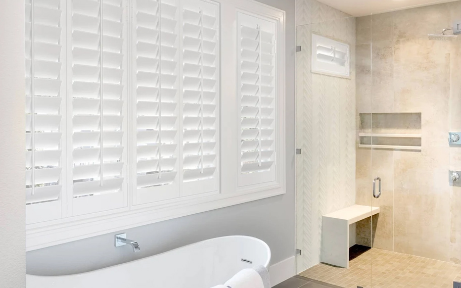 Durable Polywood shutters resist damage from heat and humidity. Polywood shutters in a bathroom.