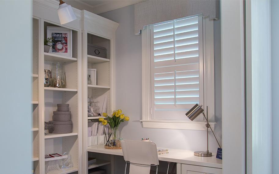 Choose custom-made interior shutters to upgrade your home office in . Home office with white polywood shutters