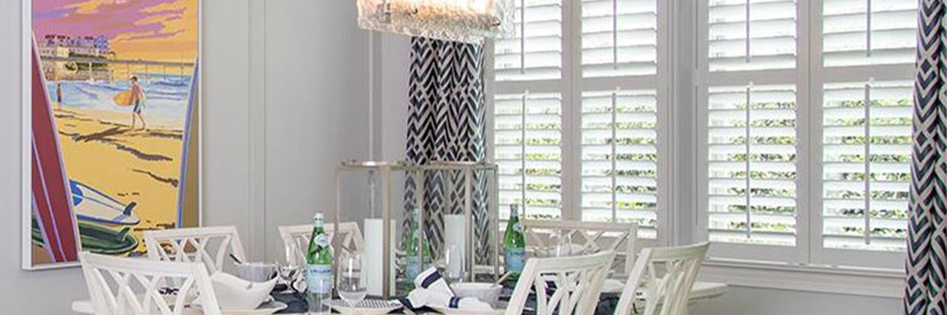 Spacious dining room with white Polywood shutters.