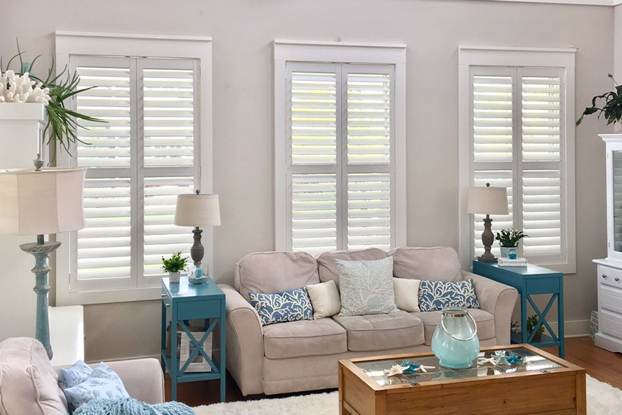 Beach-style house with white polywood shutters.