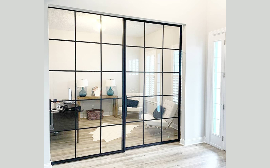 Glass panels within a sliding barn door.