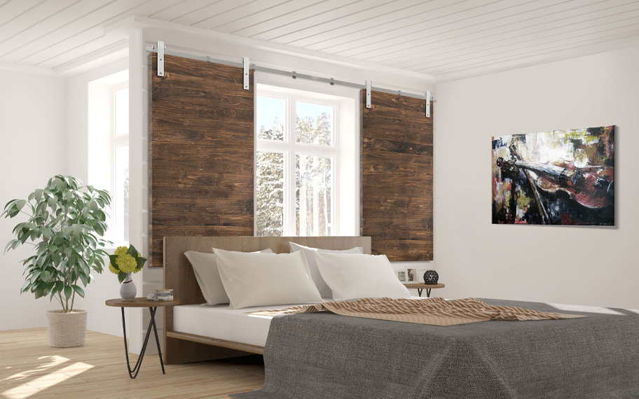 Farmhouse style barn door shutter in a bedroom.