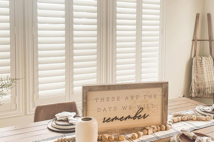 White Polywood shutters in a dining room.