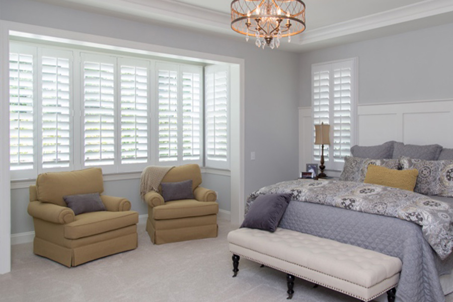 Split-tilt rod windows in a large bedroom.