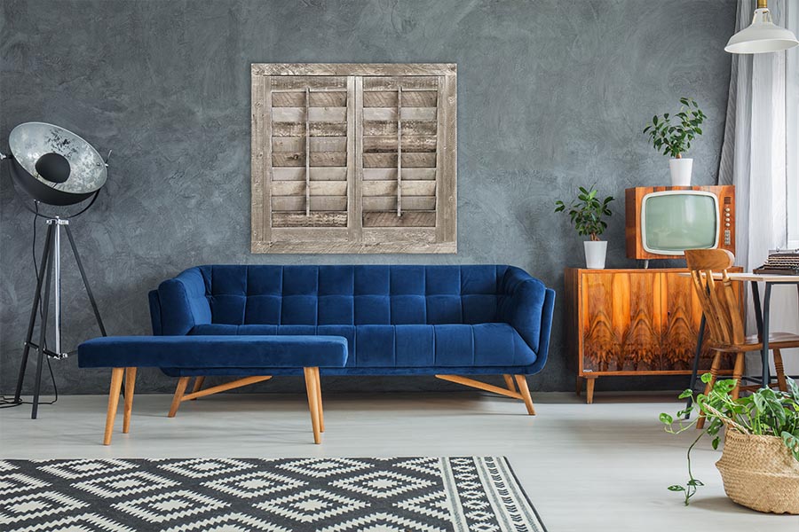 Reclaimed wood shutters above a blue couch