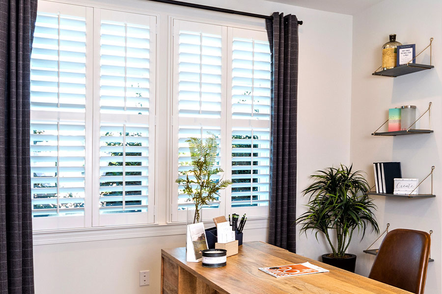 White Polywood shutters inside a modern-style office.