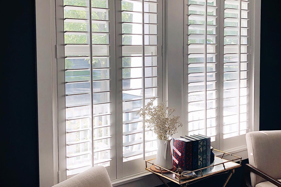 White craftsman polywood shutters in a small living room..