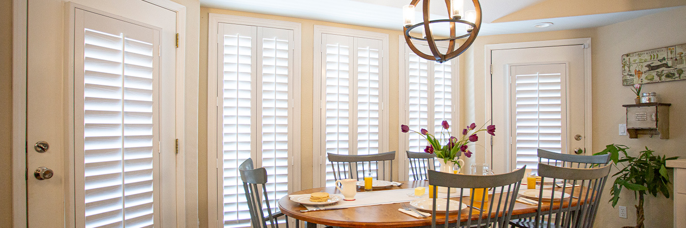 Faux wood plantation shutters in traditional eat-in kitchen