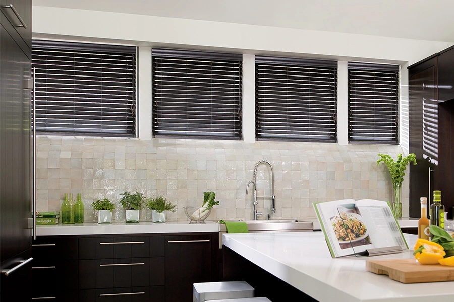 These dark brown custom window blinds perfectly match the cabinetry in this kitchen. Dark brown custom window blinds in a stylish kitchen