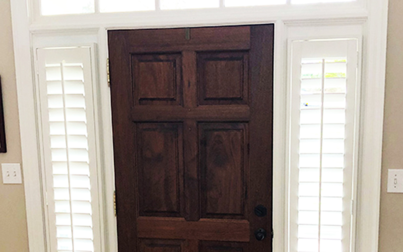 White Polywood shutters on sidelights with the front door.