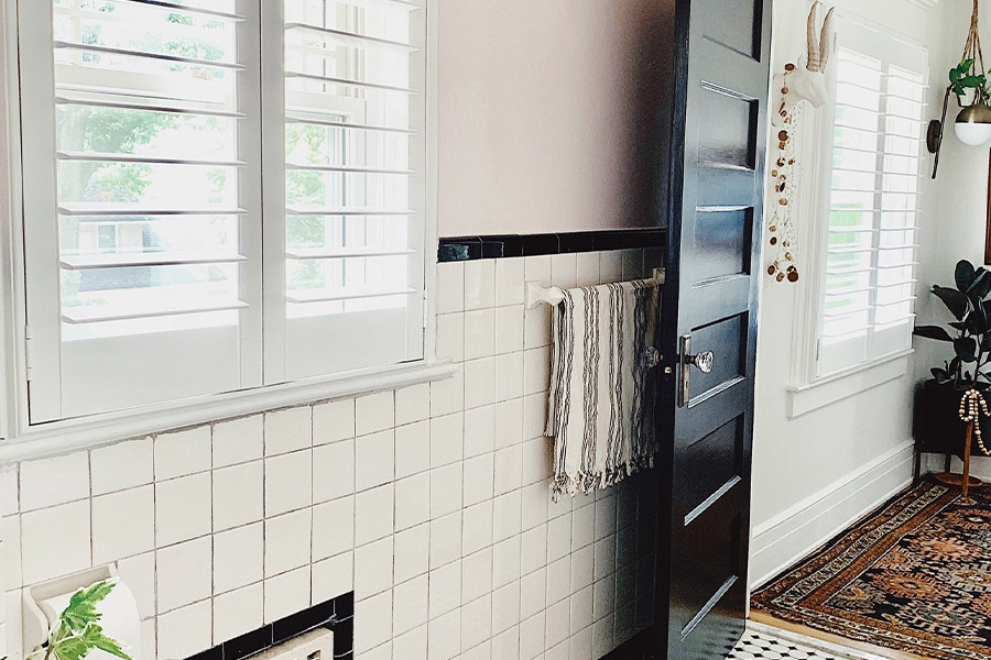 White faux-wood Polywood shutters are an elegant window treatment for egress windows. Photo Credit: House of Six Interiors. White polywood shutters in a bathroom and living room.