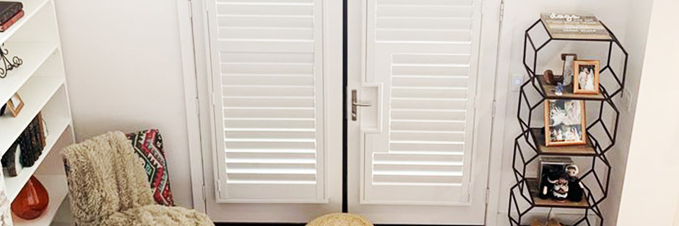 White Polywood French doors inside an entryway.