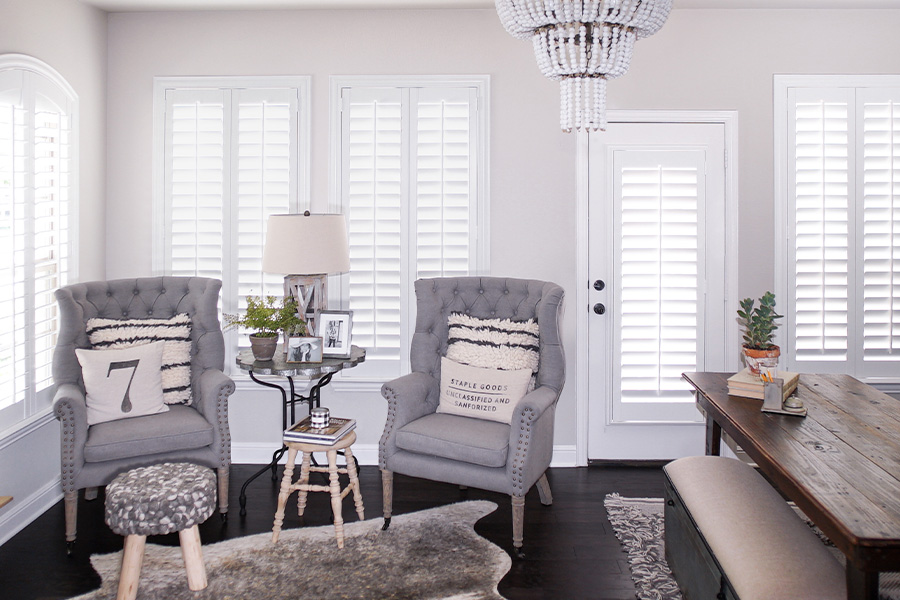 White Polywood shutters on one French door within a living room.