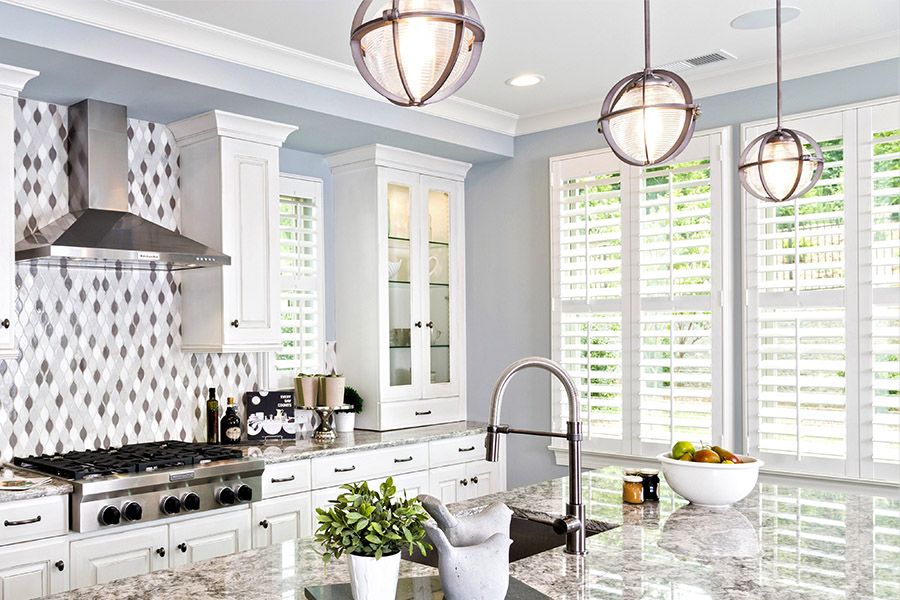 Stylish kitchen with modern fixtures and a black and gray backsplash.