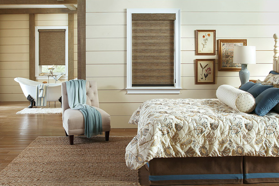 Dark brown woven shades in a natural styled bedroom