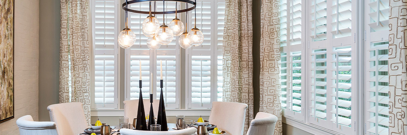 White polywood shutters in a fancy dining room