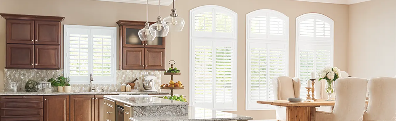 Arched white plantation shutters in a large modern kitchen