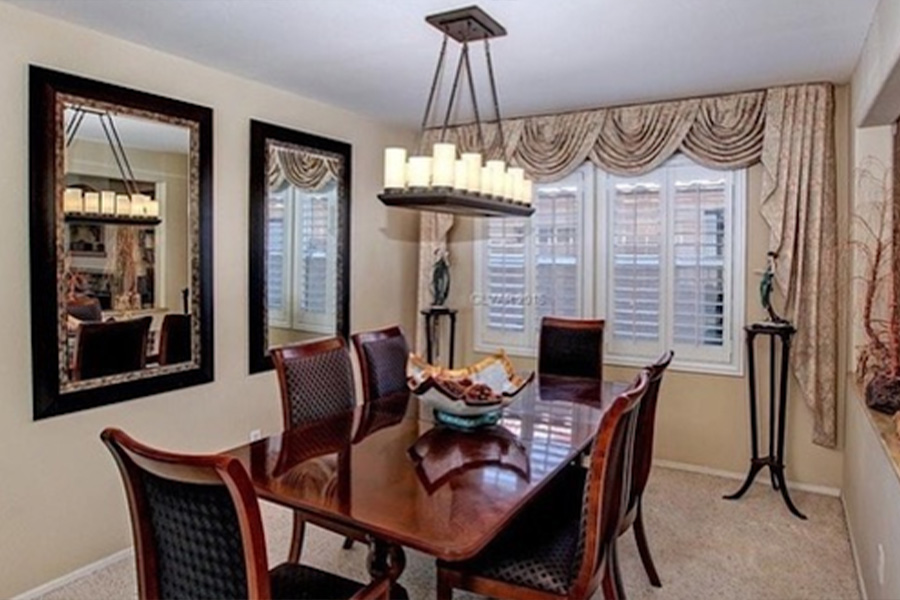 White shutters with a valance in a dining room