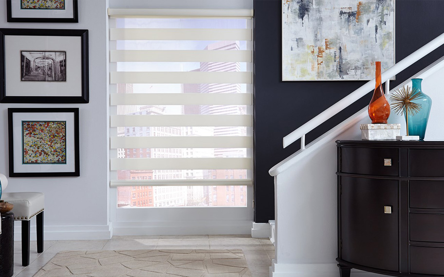 A small amount of pattern on your zebra roller shades can go a long way. Off-white zebra blinds by a staircase