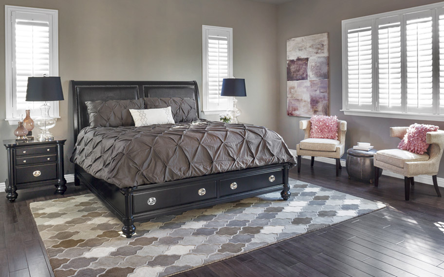 Crisp white Polywood shutters go well with any color scheme. Photo Credit: Room Solutions White polywood shutters in a modern and decorative primary bedroom