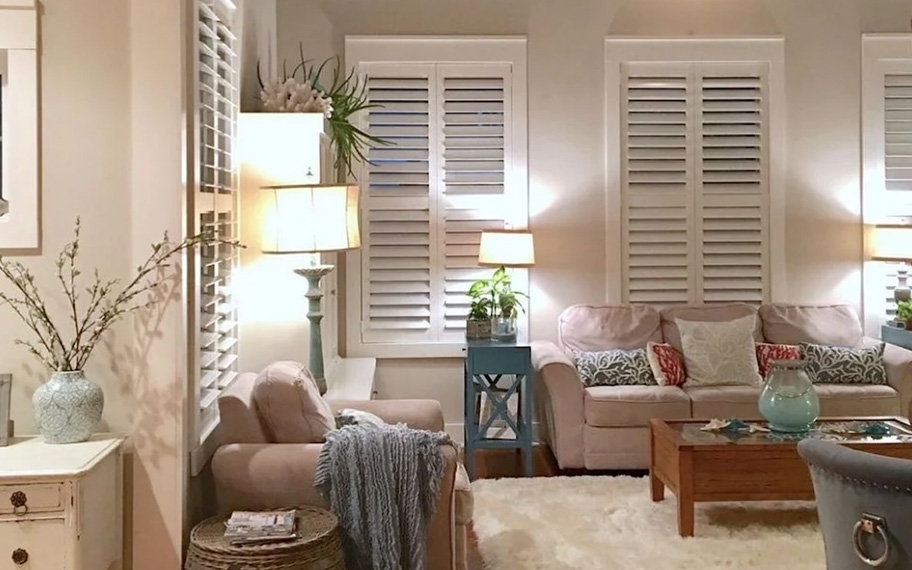 White polywood shutters in a living room corner.