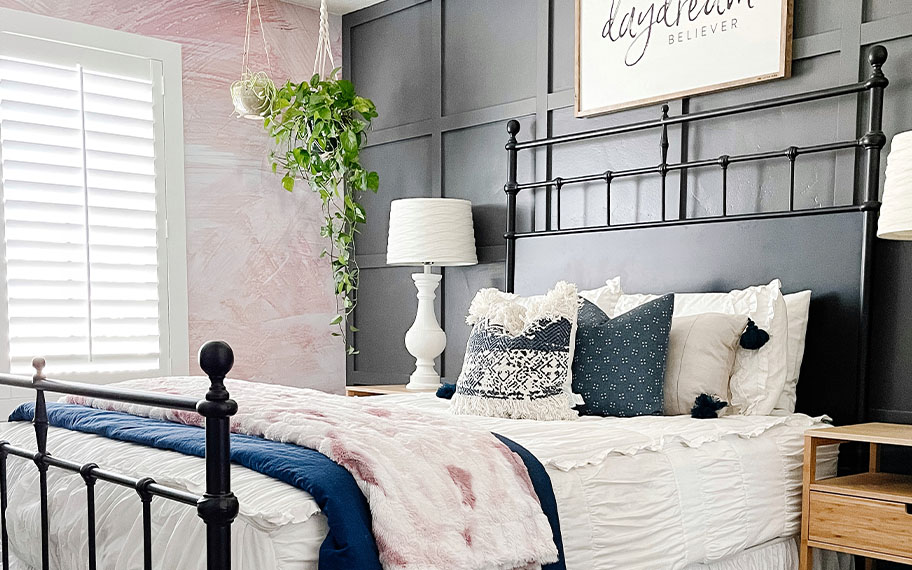 White polywood shutters in a light and airy bedroom.