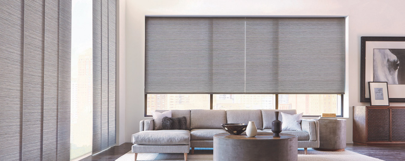 Gray motorized shades in a large modern living room.
