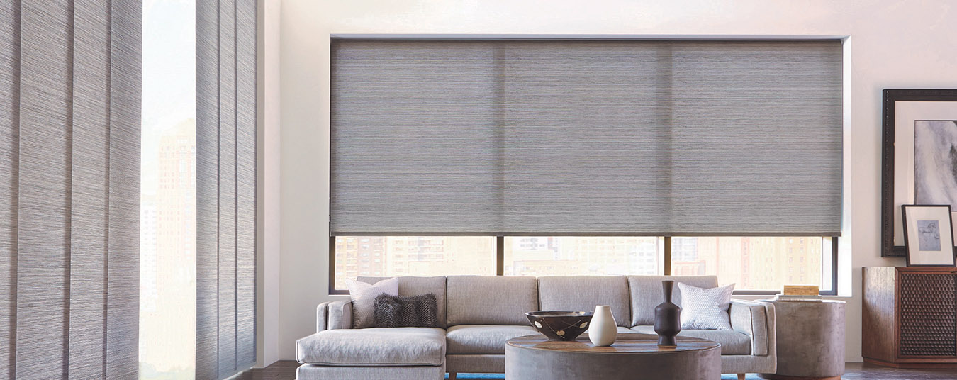 Gray motorized shades in a large modern living room.
