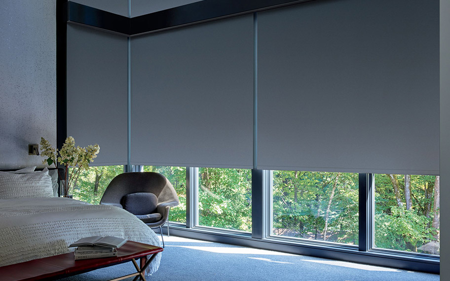 dark roller shades in a large modern bedroom