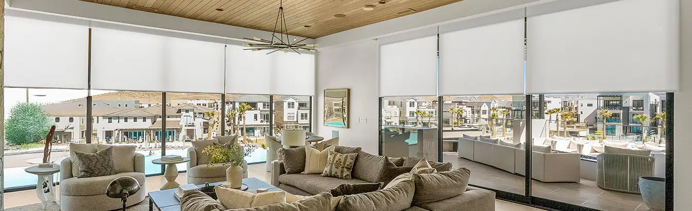 White motorized shades in a large modern living room.