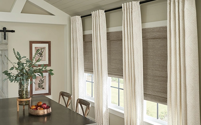 Beige draperies in a large dining room with farmhouse styled decor